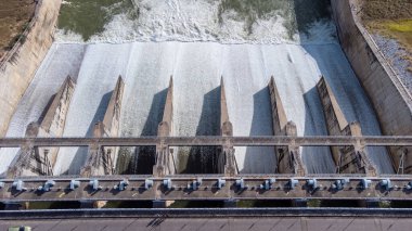 An aerial view over the Pasak Jolasid dam, Lopburi Province, Thailand. Tracking the movement of the floodgates that are releasing water into rural canals in enormous amounts of water.