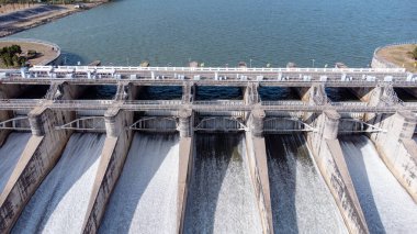 An aerial view over the Pasak Jolasid dam, Lopburi Province, Thailand. Tracking the movement of the floodgates that are releasing water into rural canals in enormous amounts of water.