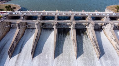 An aerial view over the Pasak Jolasid dam, Lopburi Province, Thailand. Tracking the movement of the floodgates that are releasing water into rural canals in enormous amounts of water.