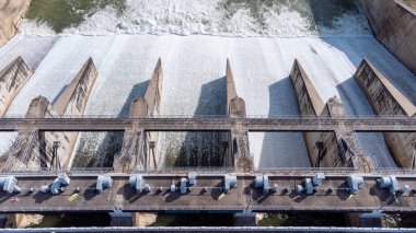 An aerial view over the Pasak Jolasid dam, Lopburi Province, Thailand. Tracking the movement of the floodgates that are releasing water into rural canals in enormous amounts of water.