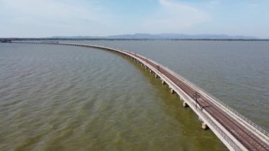An aerial view over the Pasak Jolasid dam, Lopburi Province, Thailand. Tracking the movement of the floodgates that are releasing water into rural canals in enormous amounts of water.