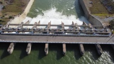 An aerial view over the Pasak Jolasid dam, Lopburi Province, Thailand. Tracking the movement of the floodgates that are releasing water into rural canals in enormous amounts of water.