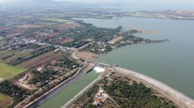 An aerial view over the Pasak Jolasid dam, Lopburi Province, Thailand. Tracking the movement of the floodgates that are releasing water into rural canals in enormous amounts of water.