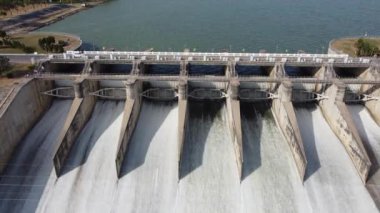 An aerial view over the Pasak Jolasid dam, Lopburi Province, Thailand. Tracking the movement of the floodgates that are releasing water into rural canals in enormous amounts of water.