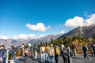 Japon Alpleri, Shinhotaka Ropeway, Japonya - Ekim 2023: Sonbahar renklerinde ana turistik ilgi merkezi Shin Hotaka 'nın atmosferi teleferik ve halatla turistlere sonbahar yeşilliklerinde hizmet veriyor..