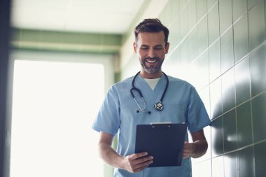 Mutlu doktor tıbbi belgeleri okuyor.