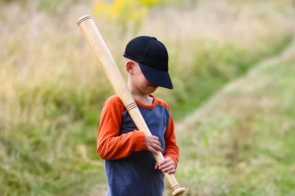 stock image Happy child with baseball bat on nature concept in park