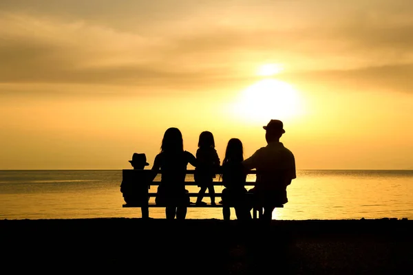 happy family in nature by the sea on a trip silhouette
