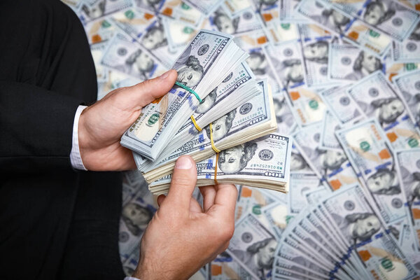 Happy guy with money in his hands for the development of shopping business and a great trip