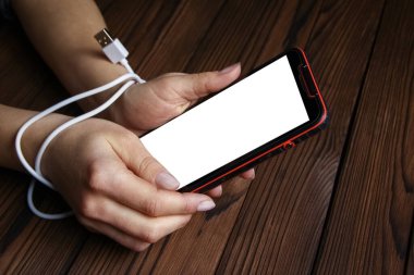 Telefon ahşap bir arka planda el bağımlılığı