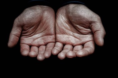 Hands of a begging poor man on the street bum