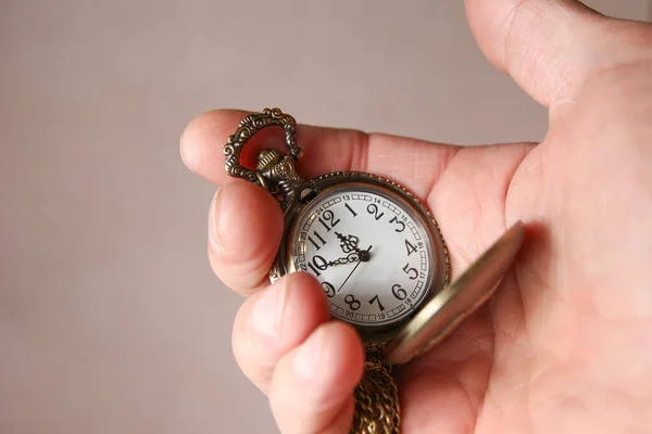 pocket watch in the hands of a man