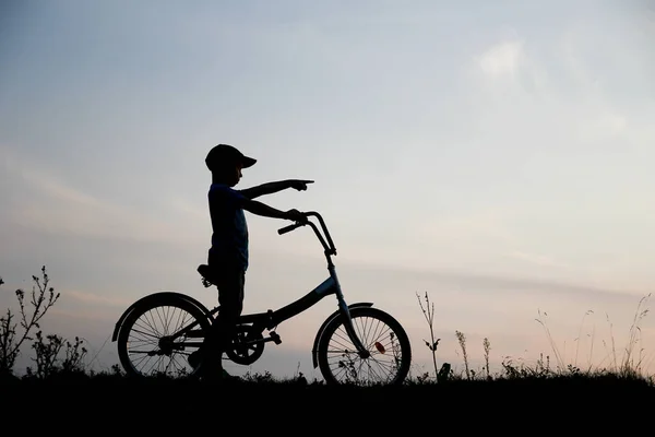 Stock image silhouette Happy child and bike concept in park summer sport