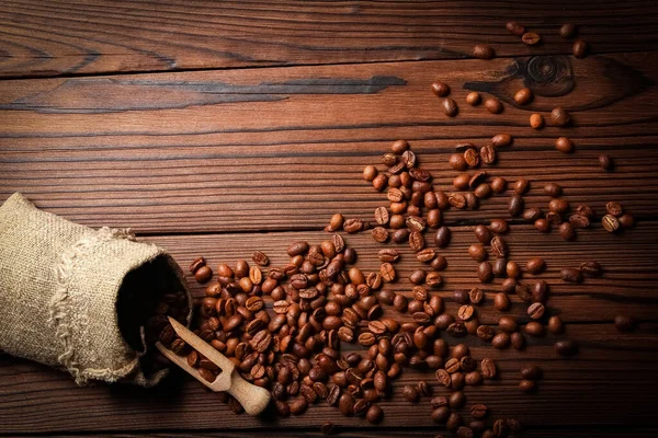木制背景的咖啡豆袋 — 图库照片