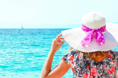 Happy girl on the shore of the sea in travel vacation