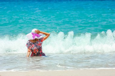 Happy girl on the shore of the sea in travel vacation