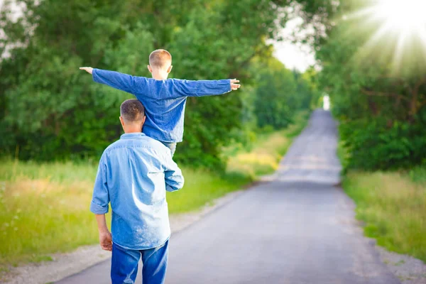 在大自然中 快乐的孩子在父母的肩上走在旅行的路上 — 图库照片