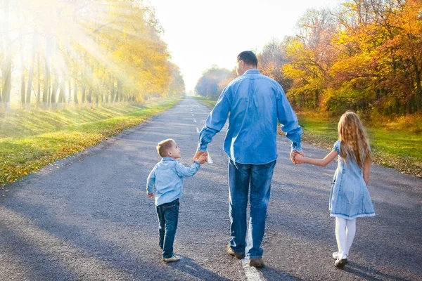 快乐的父母带着孩子在公园的路上散步 — 图库照片