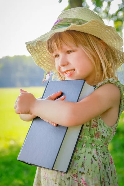 公園で聖書の性質に関する本を持つ幸せな子供 — ストック写真