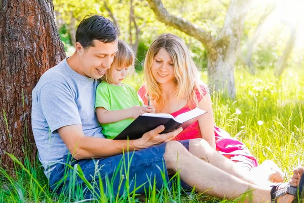 Happy Family Reading Book Nature Bible — Stock Photo, Image