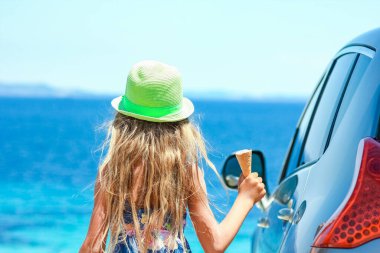 Hafta sonu deniz kenarında dondurmalı mutlu bir çocuk.