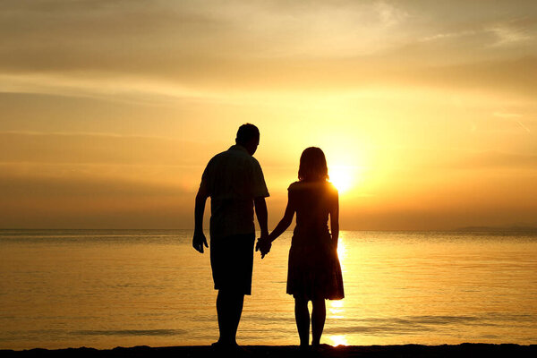 happy couple in the sea on nature travel silhouette