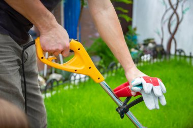 Bahçedeki çim biçme makinesi ve adam