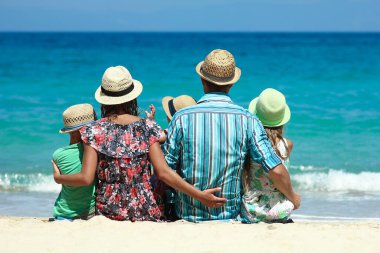 Happy family with children on the coast of the sea travel