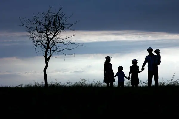 Happy family silhouette on nature in park background