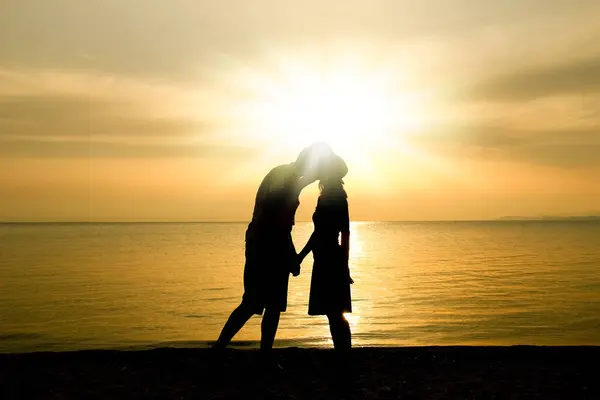 happy couple by the sea on nature in travel silhouette