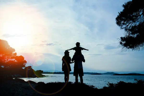 happy family in nature by the sea on a trip silhouette