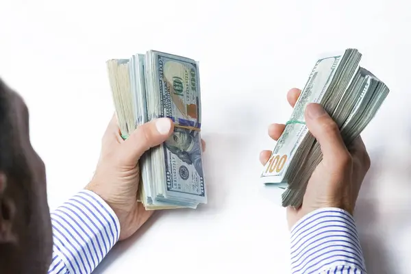 money in the hands of a business man loan concept on a white background