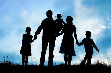 Deniz kenarında mutlu bir aile, doğanın siluetinde.