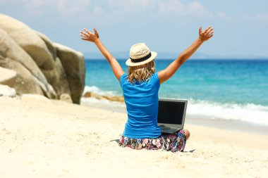 Happy man girl with laptop near the seaside weekend travel