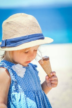 Hafta sonu deniz kenarında dondurmalı mutlu bir çocuk.