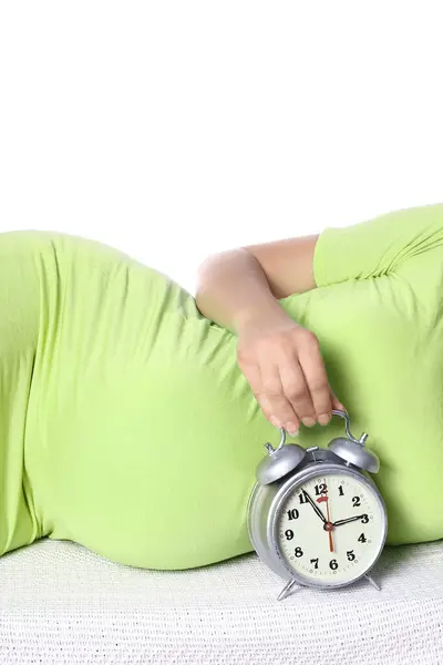 stock image Happy pregnant girl lies on white background