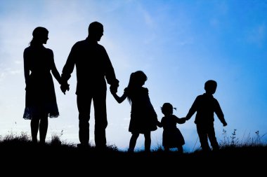 Deniz kenarında mutlu bir aile, doğanın siluetinde.