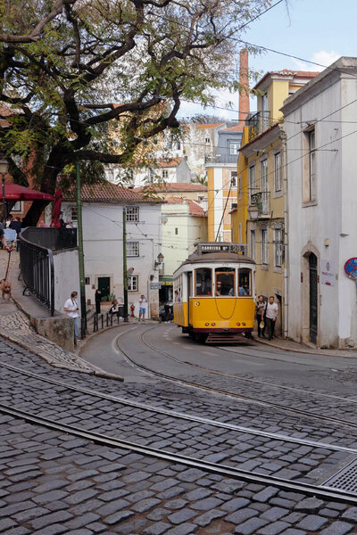 Cityscape of old buildings with yellow tram in Lisbon, Portugal