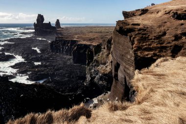 landscape of stone formation at Londrangar cliff in Iceland clipart