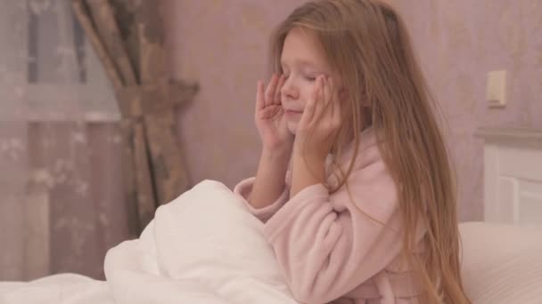 Uzun Saçlı Güzel Bir Kız Yatakta Oturuyor Gözlerini Ovuşturuyor — Stok video