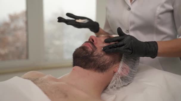 Woman Hands Black Gloves Applying Cream Man Forehead Cheekbones Beauty — Stock Video