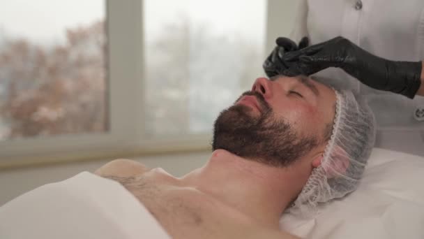 Closeup Side View Woman Hands Black Gloves Massaging Man Face — Wideo stockowe
