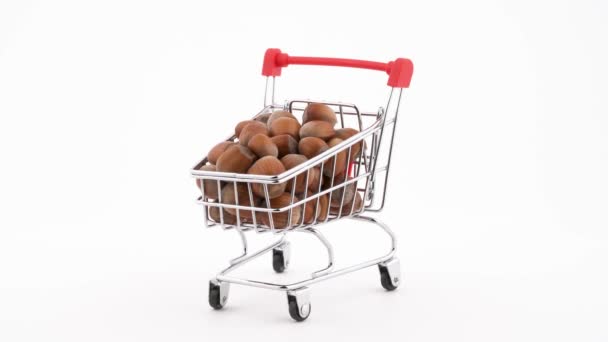 Shopping Cart Filled Hazelnuts Rotating Turntable Isolated White Background Close — 图库视频影像