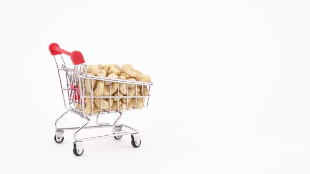 Shopping Cart Filled Cashew Nuts Moving Forward Isolated White Background — Vídeos de Stock