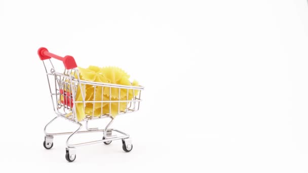 Shopping Cart Filled Farfalle Pasta Moving Forward Isolated White Background — Stockvideo