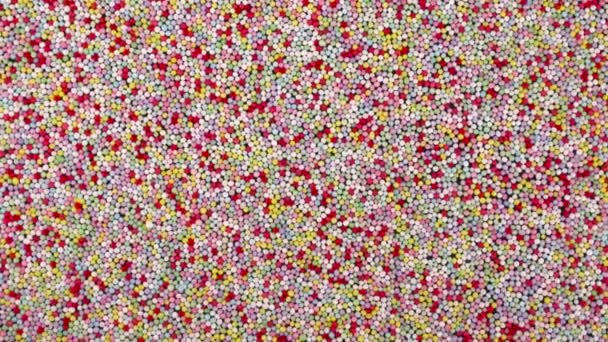 Top View Small Colorful Sprinkles Sugar Candies Rotating Background — Vídeos de Stock