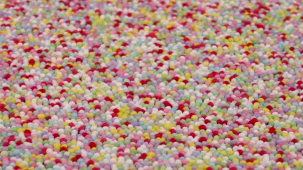Angled View Small Colorful Sprinkles Sugar Candies Rotating Background — Wideo stockowe