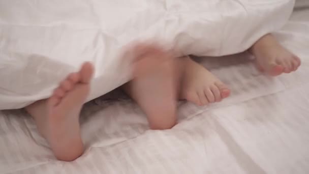 Legs Two Little Girls Sticking Out Blanket — Stock Video
