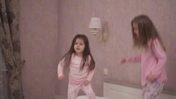 Little Funny Girls Jumping Bed — Stockvideo