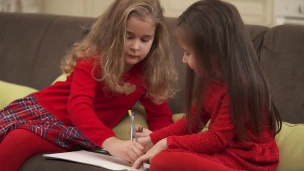 Little Girls Drawing Paper Colored Pencils — Stockvideo